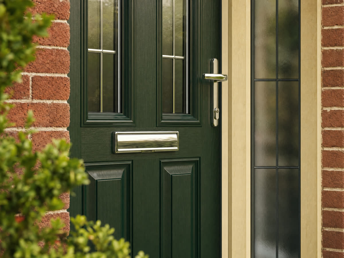 Forest-green composite front door with a woodgrain fibreglass finish